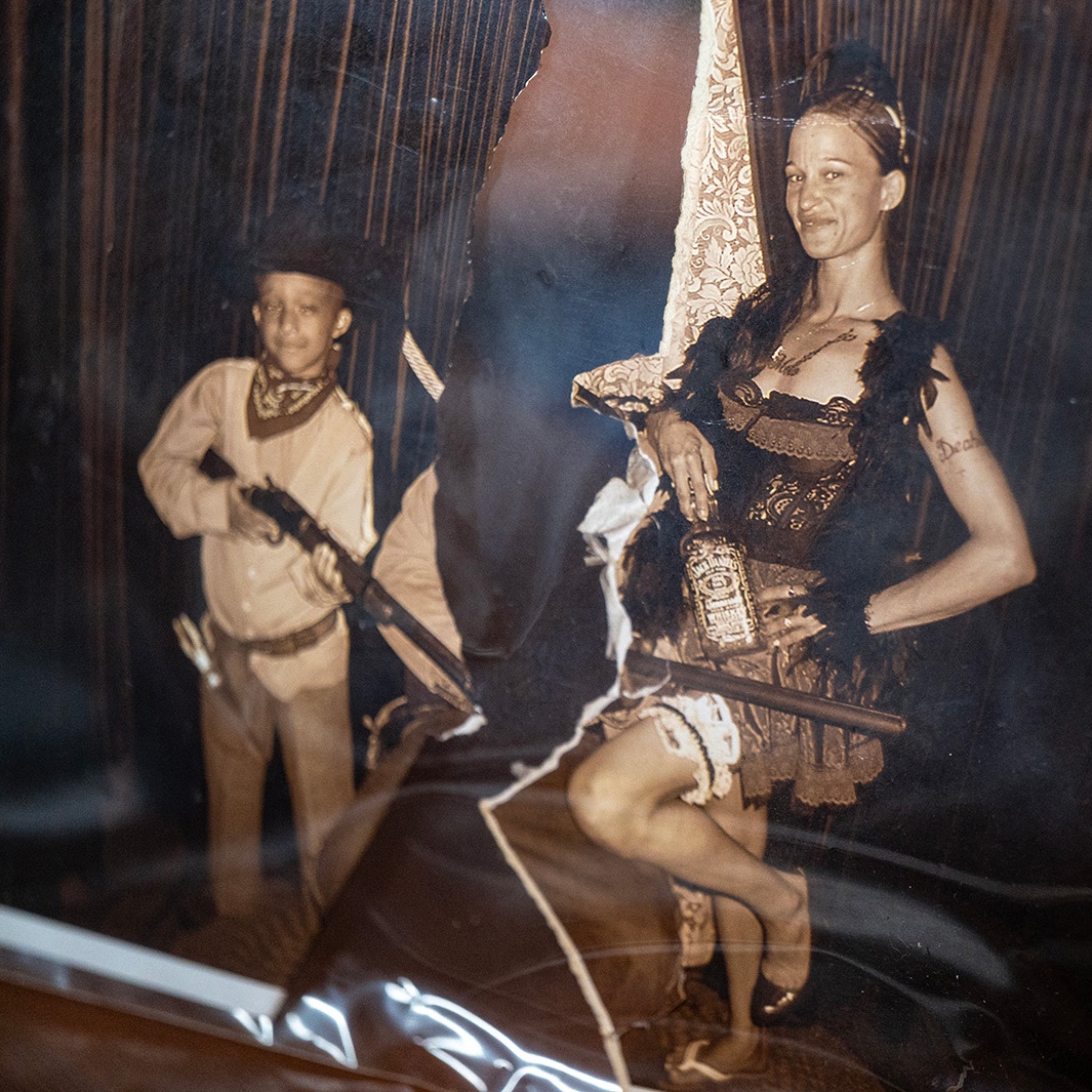 A vintage-looking tintype-style photograph of a mother and her son