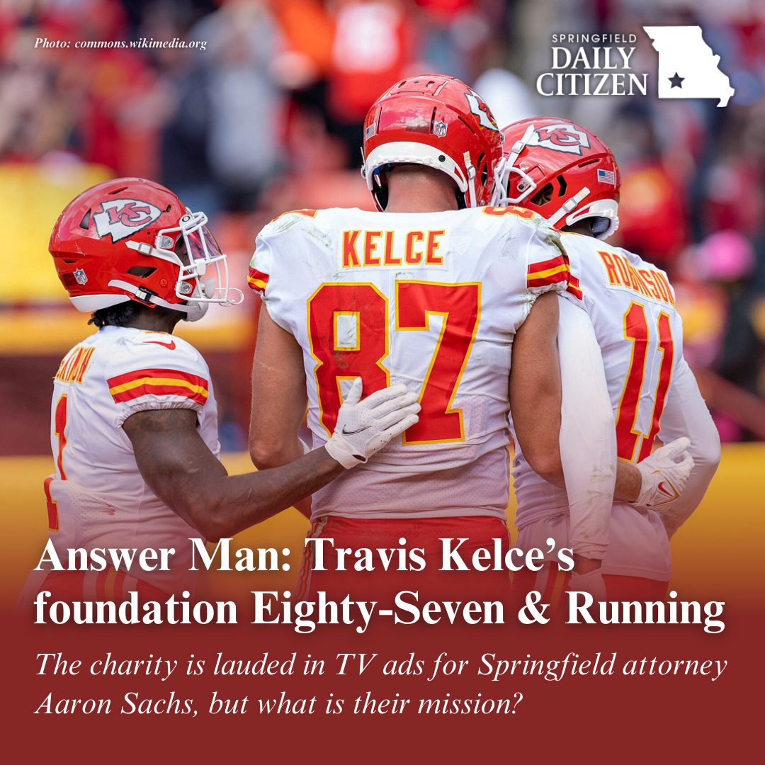 Travis Kelce, number 87, gathers with other players at a game in October 2021. Text on the image reads, "Answer Man: Travis Kelce's foundation Eighty-Seven & Running. The charity is lauded in TV ads for Springfield attorney Aaron Sachs, but what is their mission?" (Photo: commons.wikimedia.org) 