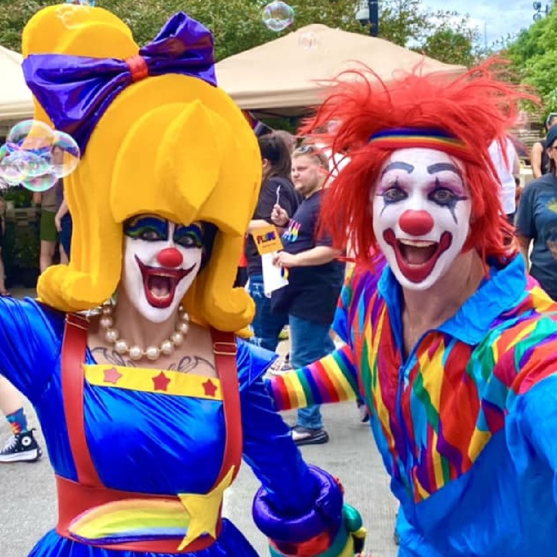 A woman and man dressed as clowns