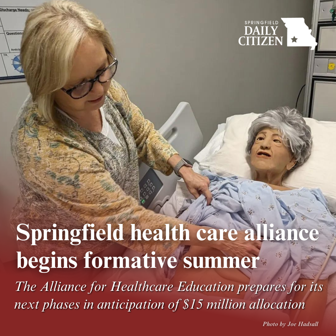 Christina Liles, simulation specialist with Cox College, shows details of a training dummy intended to mimic an elderly person. Text on the image reads: "Springfield health care alliance begins formative summer. The Alliance for Healthcare Education prepares for its next phases in anticipation of $15 million allocation." (Photo by Joe Hadsall)