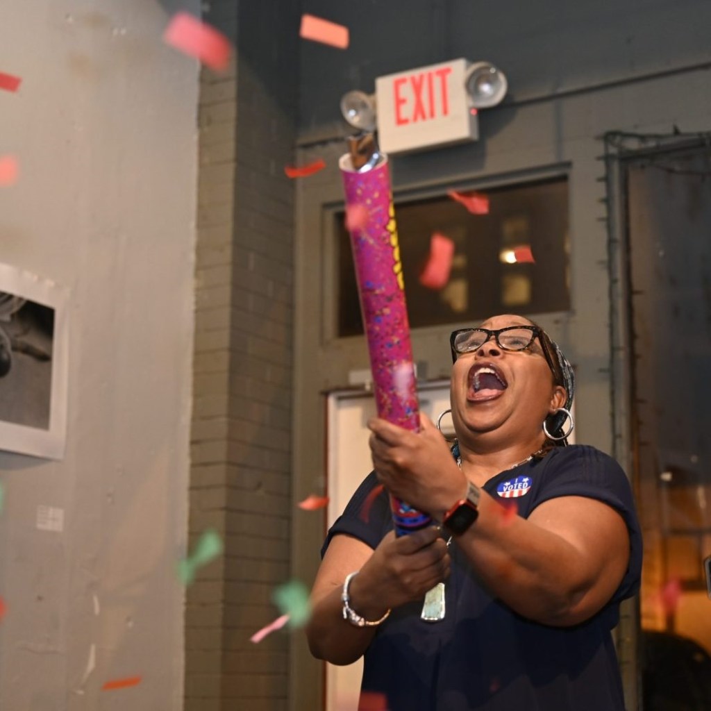 A woman shoots off a confetti cannon