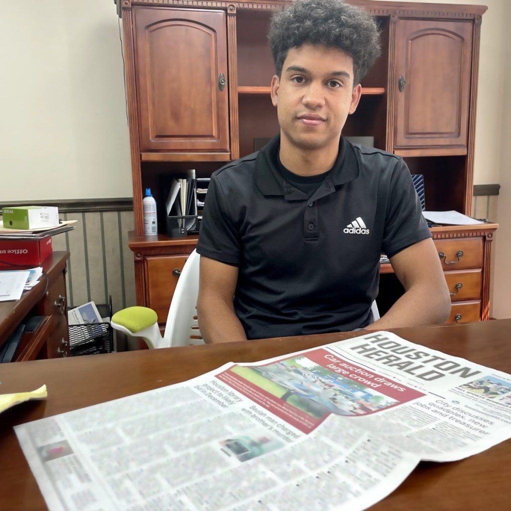 Isaiah Buse sits at the desk in his office at the Houston Herald