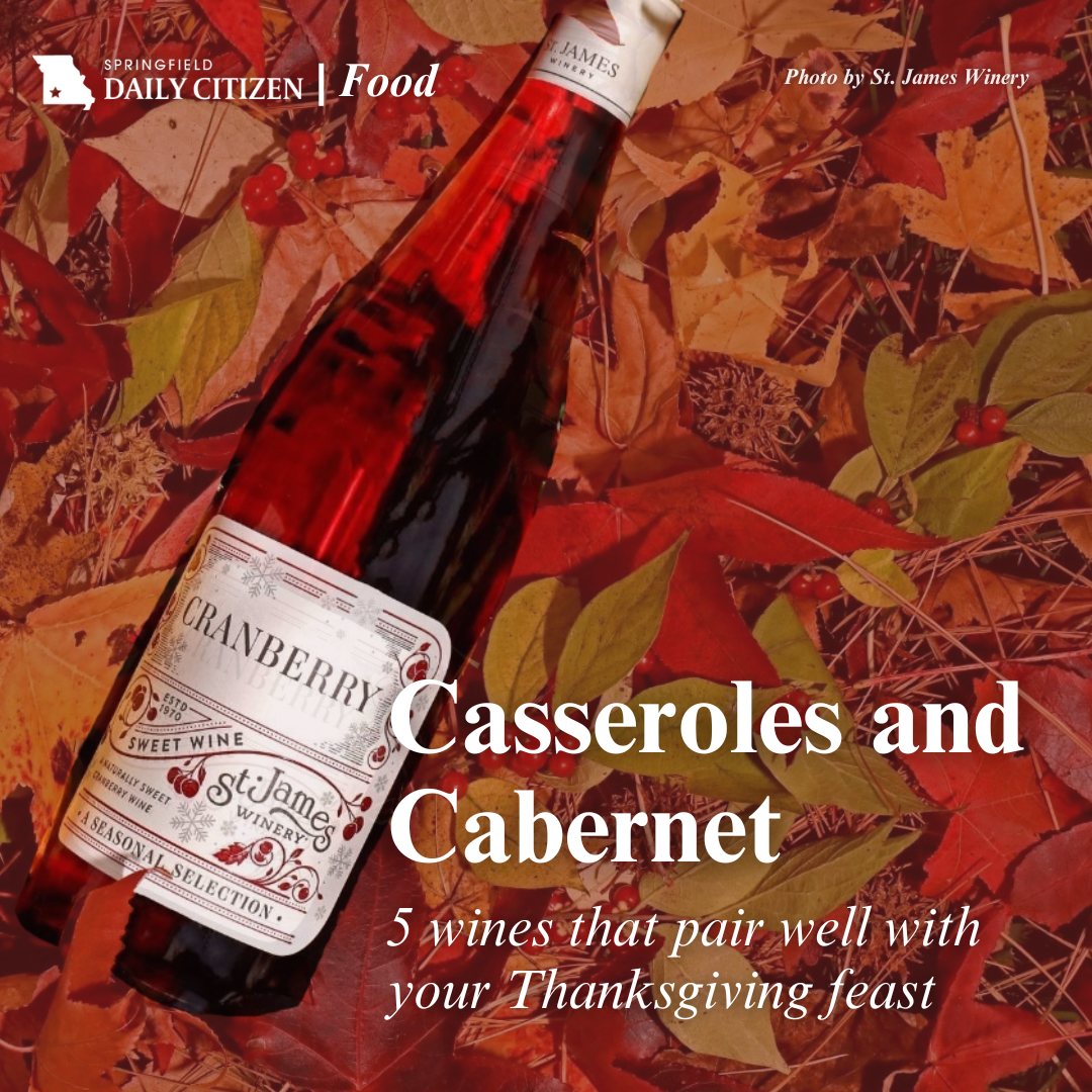 A bottle of St. James Cranberry wine rests on a bed of fall leaves. Text on the image reads: "Casseroles and Cabernet. 5 wines that pair well with your Thanksgiving feast."