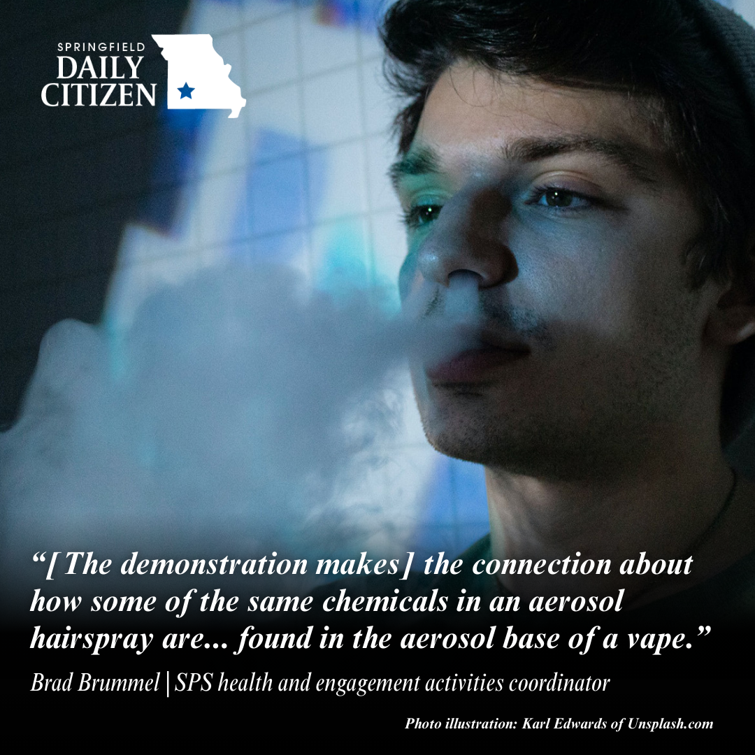 A high school student exhales smoke through their nose. Text on the image reads "[The demonstration makes] the connection about how some of the same chemicals in an aerosol hairspray are... found in the aerosol base of a vape." Brad Brummel | SPS health and engagement activities coordinator