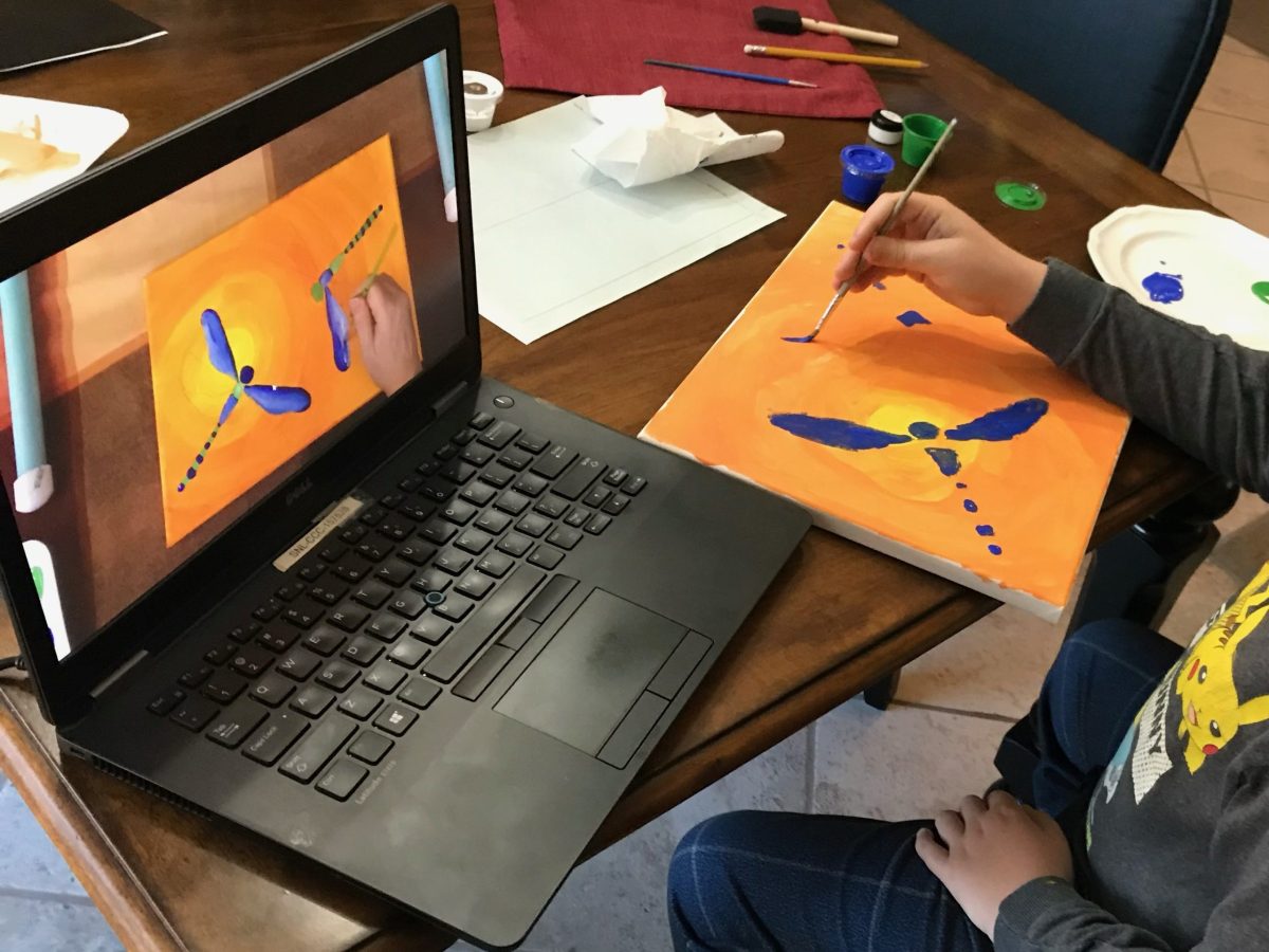 Student learns art techniques using a lap top.
