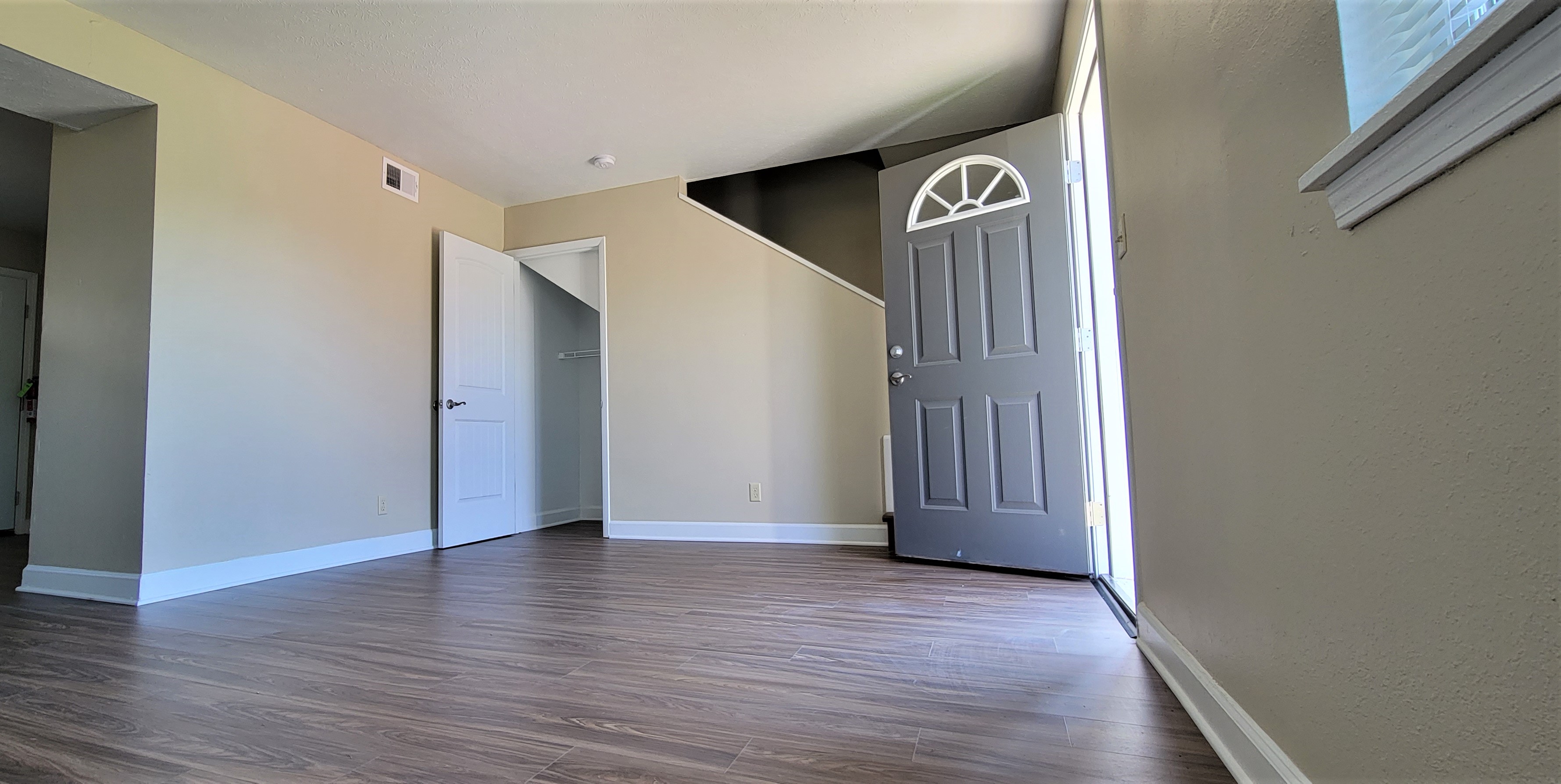 Inside one of the newly renovated Keystone Family Apartment Buildings. Fresh Tan Paint with White Trim and Gray Door.