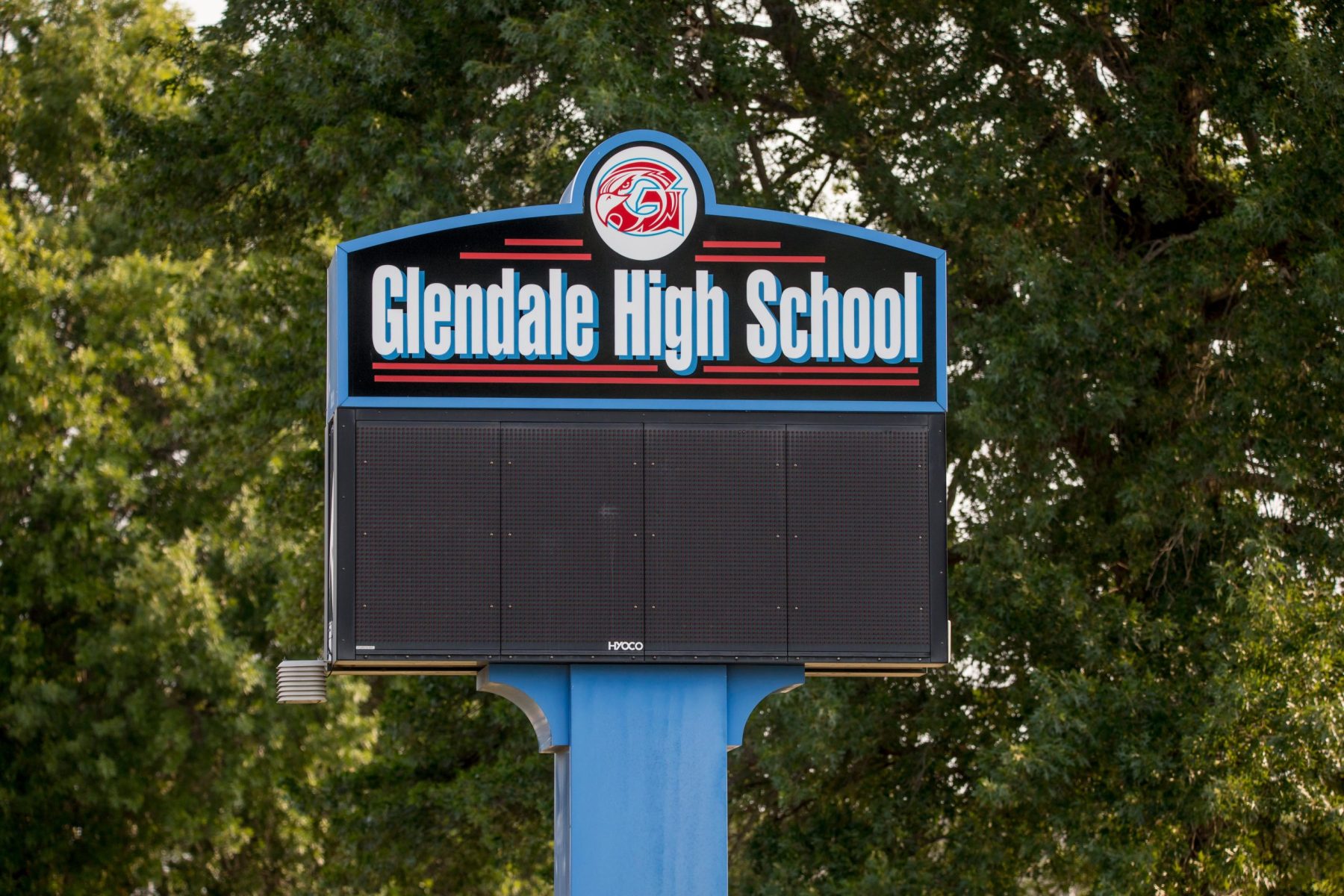 The Glendale High School sign with trees in the background.