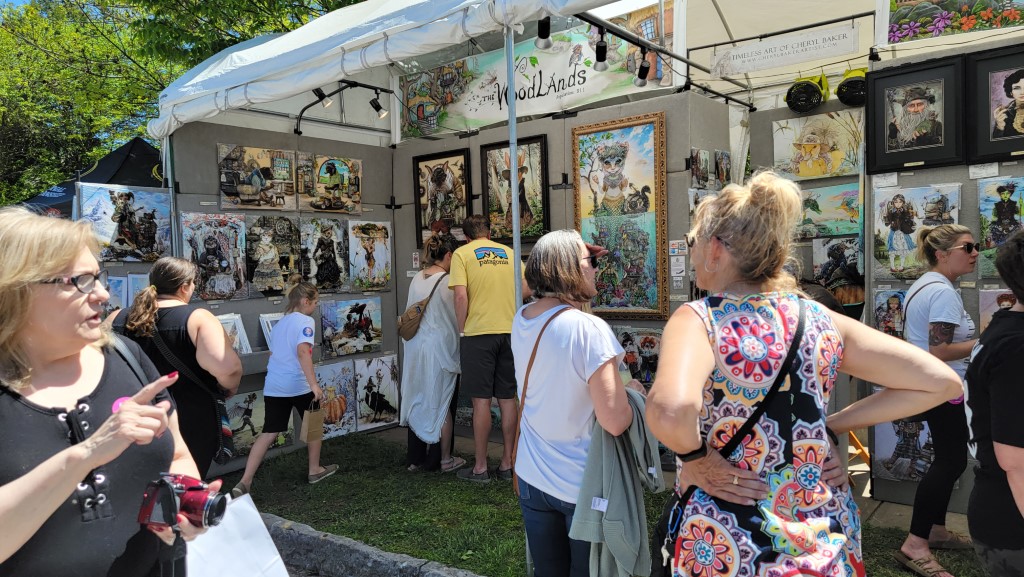 Patrons shop at an artist's tent during Artsfest on Historic Walnut Street