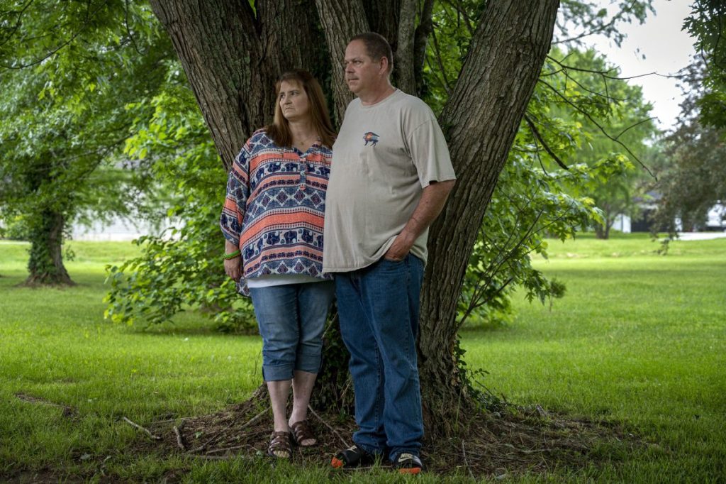 Kevin and Carol Winslow, the parents of Sean Winslow at their home in Highlandville, MO. Sean died in Feb., 2022 at age 27 after falling and hitting his head after being tased by Greene County deputy sheriffs in Springfield, MO, on January 28, 2022. The maple tree they are standing under was planted by KevinÕs father. Sean played in it as a child and once climbed it to rescue a peacock from the upper branches.