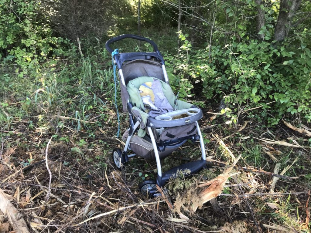 This is a baby stroller left in the woods where homeless people had been camping in west Springfield.