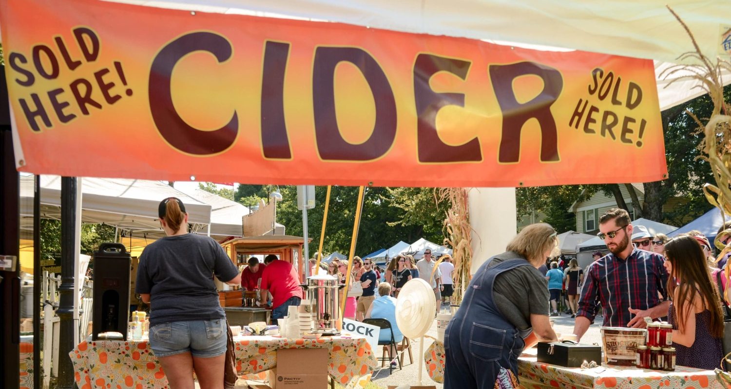 A stand sells apple cider