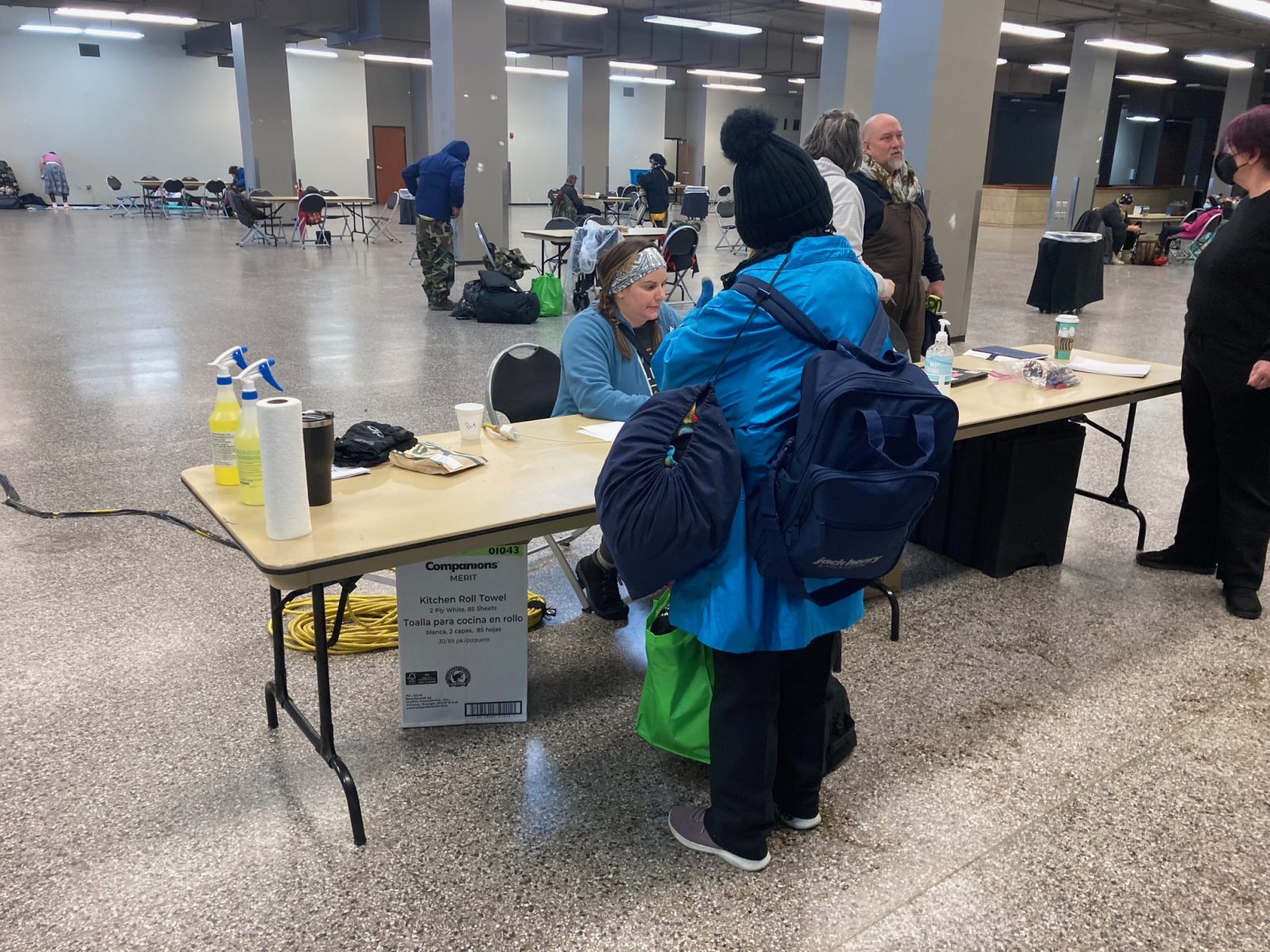 A volunteer checks a person into the emergency warming shelter at the Expo Center.
