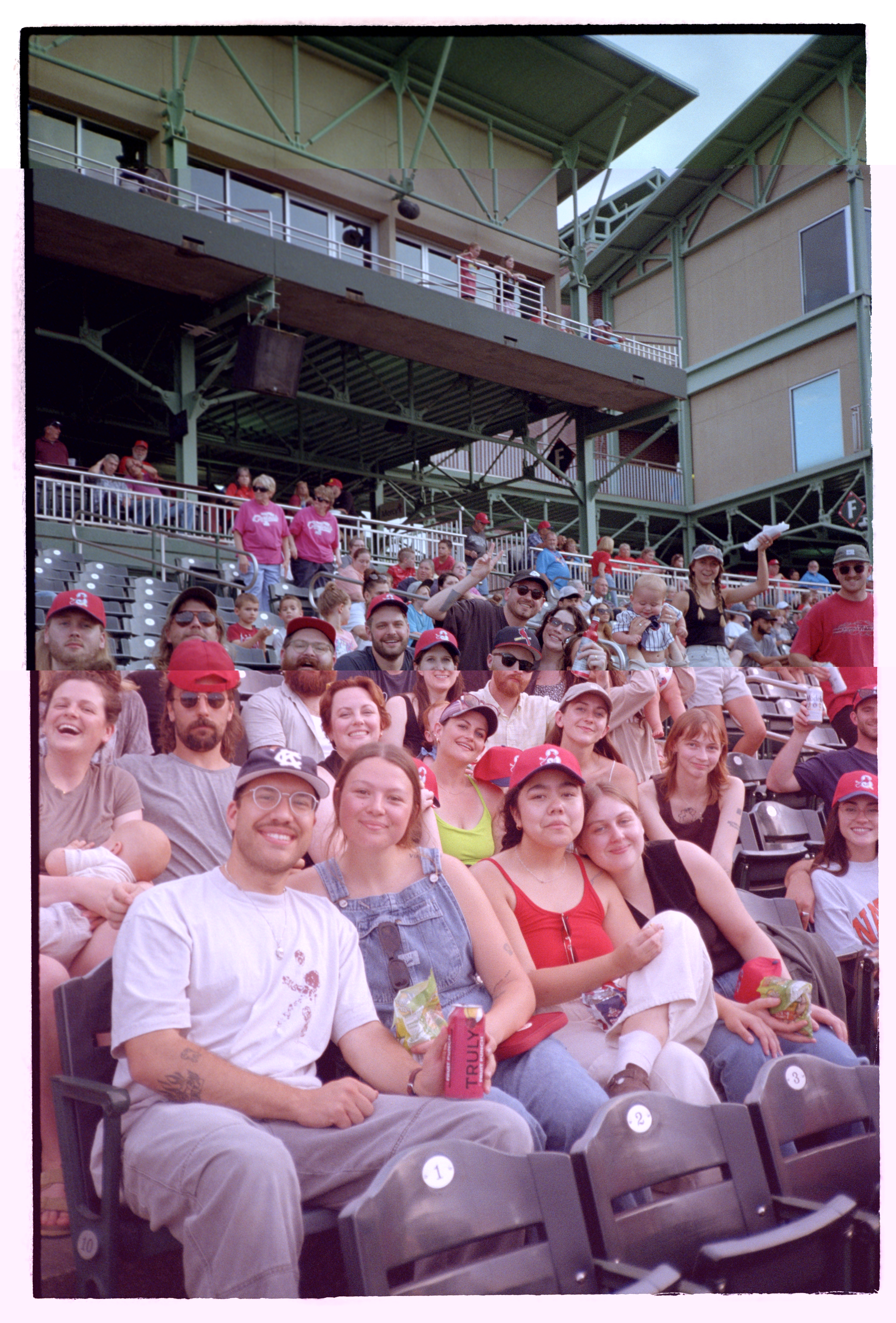 Fans at a baseball game pose for a group photo
