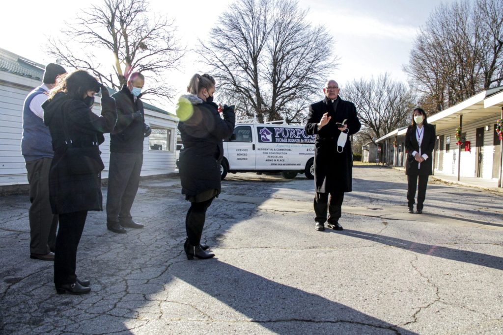 In this submitted photo from December of 2022, Catholic Charities of Southern Missouri staff participate in a blessing of the Rancho Temporary Emergency Shelter by Bishop of Springfield-Cape Girardeau Edward M. Rice