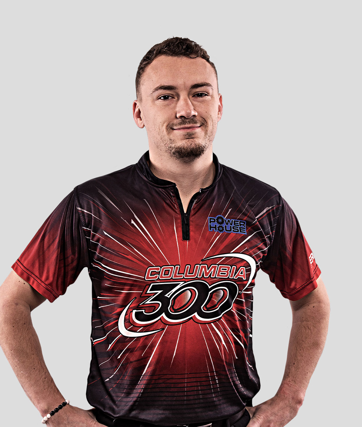 A man in a bowling shirt poses for a photo