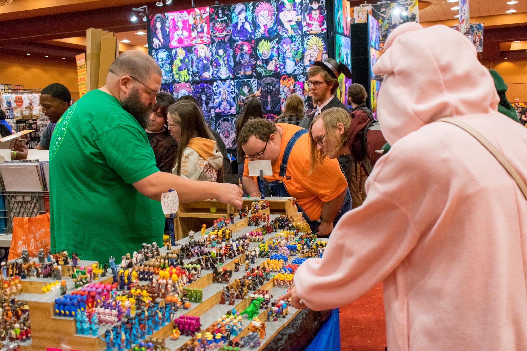 People browse a table filled with mini figurines