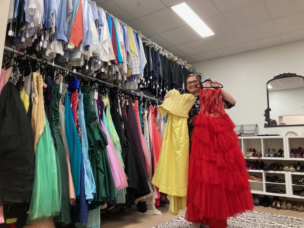 Amanda Ingle, with Council of Churches of the Ozarks, shows off a few dresses from the Prom Closet, where teens can pick out gently used formal wear.