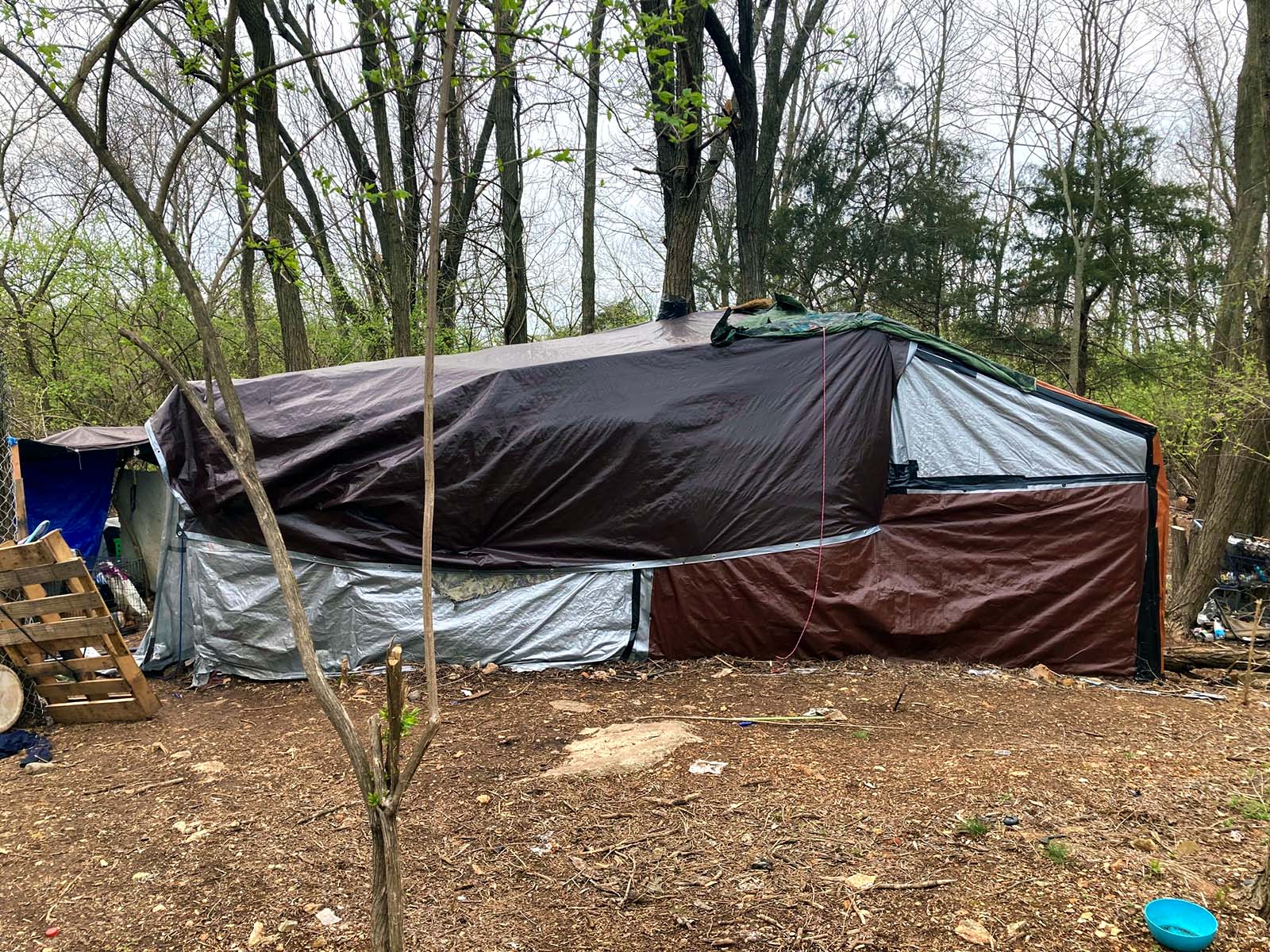 This is a tent structure a homeless person built. It is at least 20 feet long.