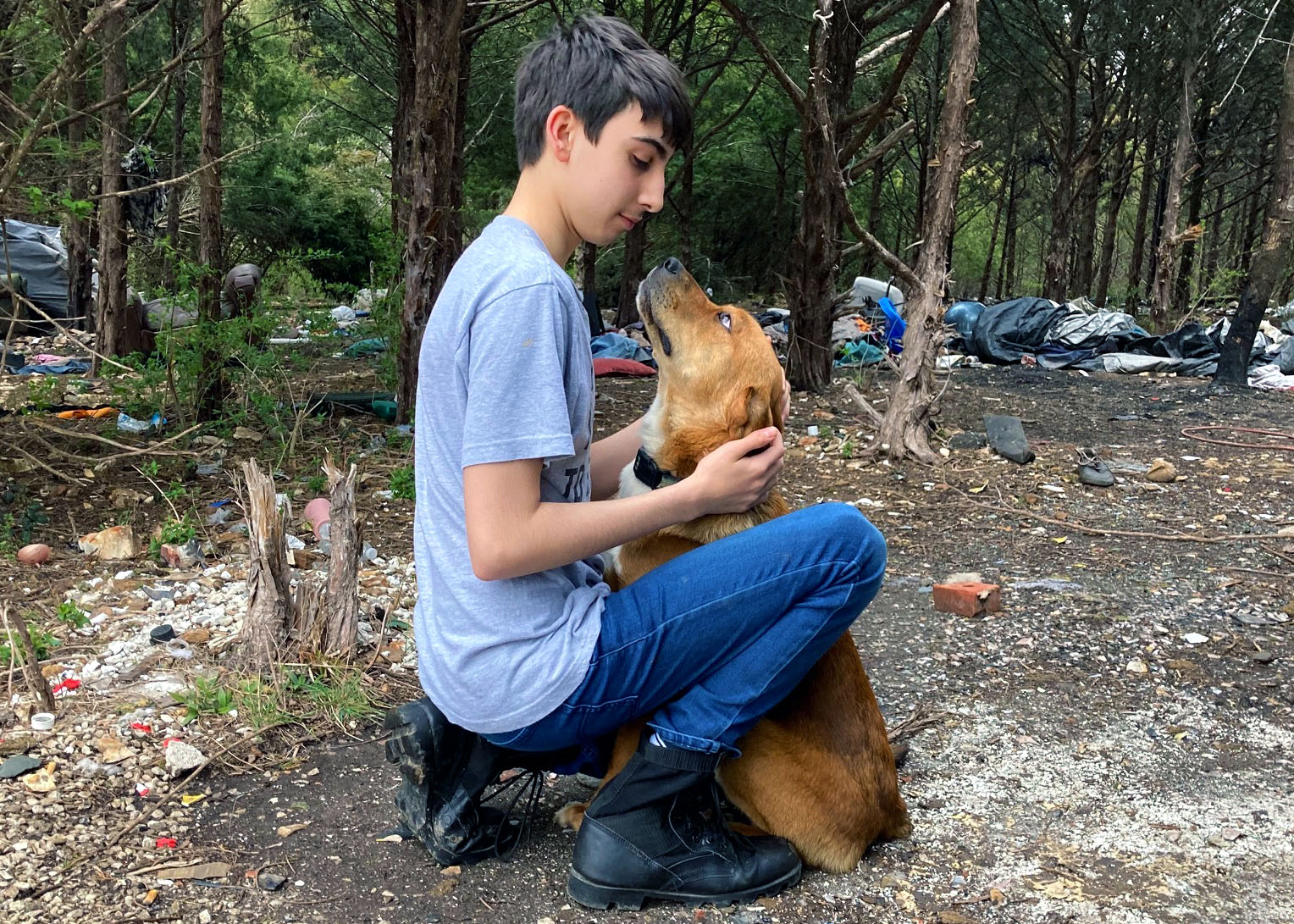 Anthony Carmichael pets a dog named Wazoo