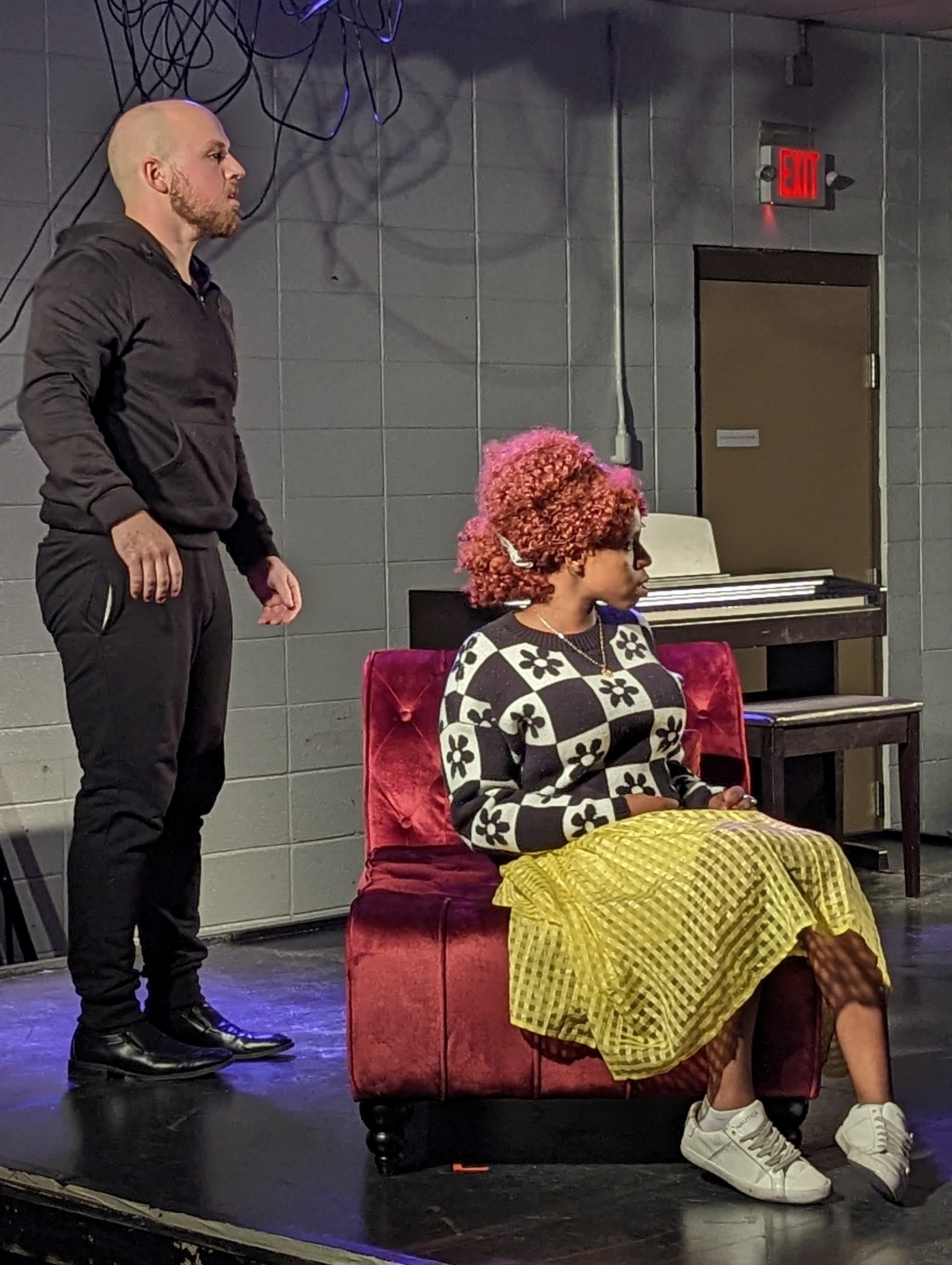 Two actors on a stage rehearse a scene from "Hedda Gabler."
