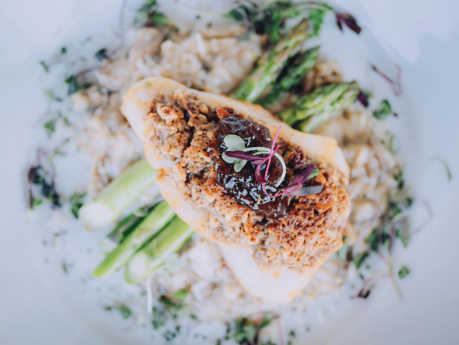 A salmon filet sits on a bed of mushroom risotto