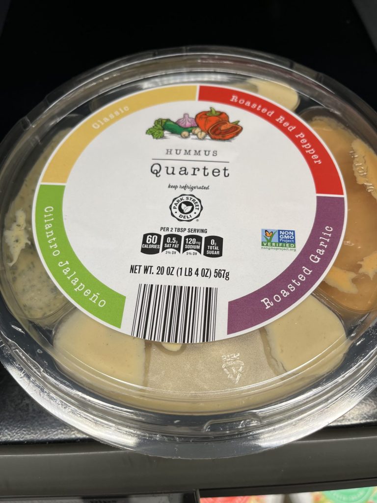 A hummus sampler in a plastic container