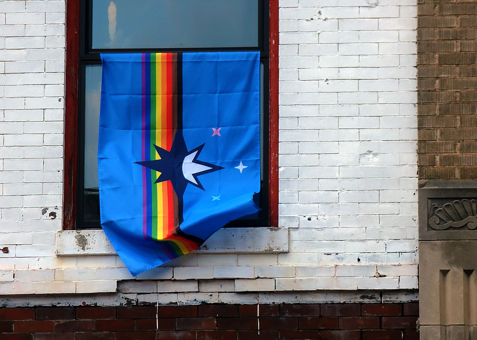 Springfield pride flag hanging outside window.