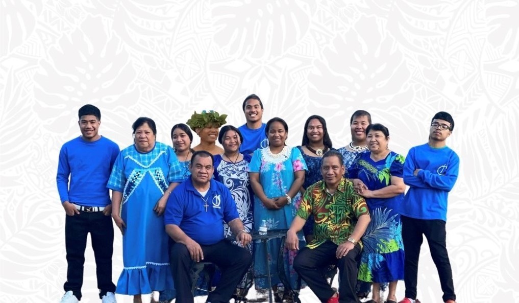 A group of Marshallese people in blue shirts pose for a group photo