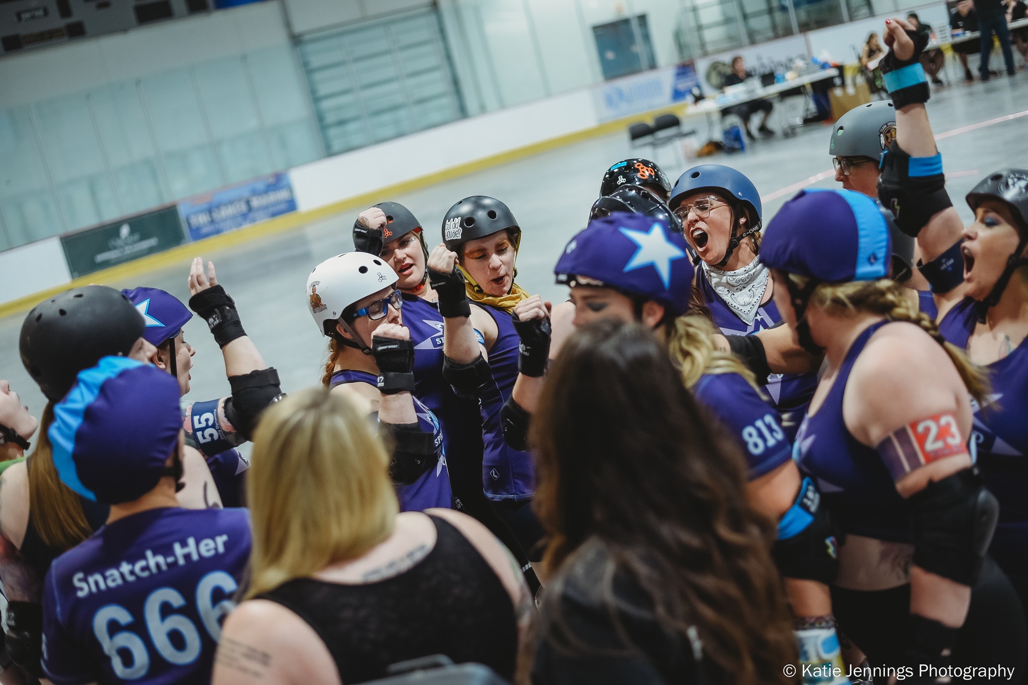 Members of Springfield Roller Derby gather in a circle