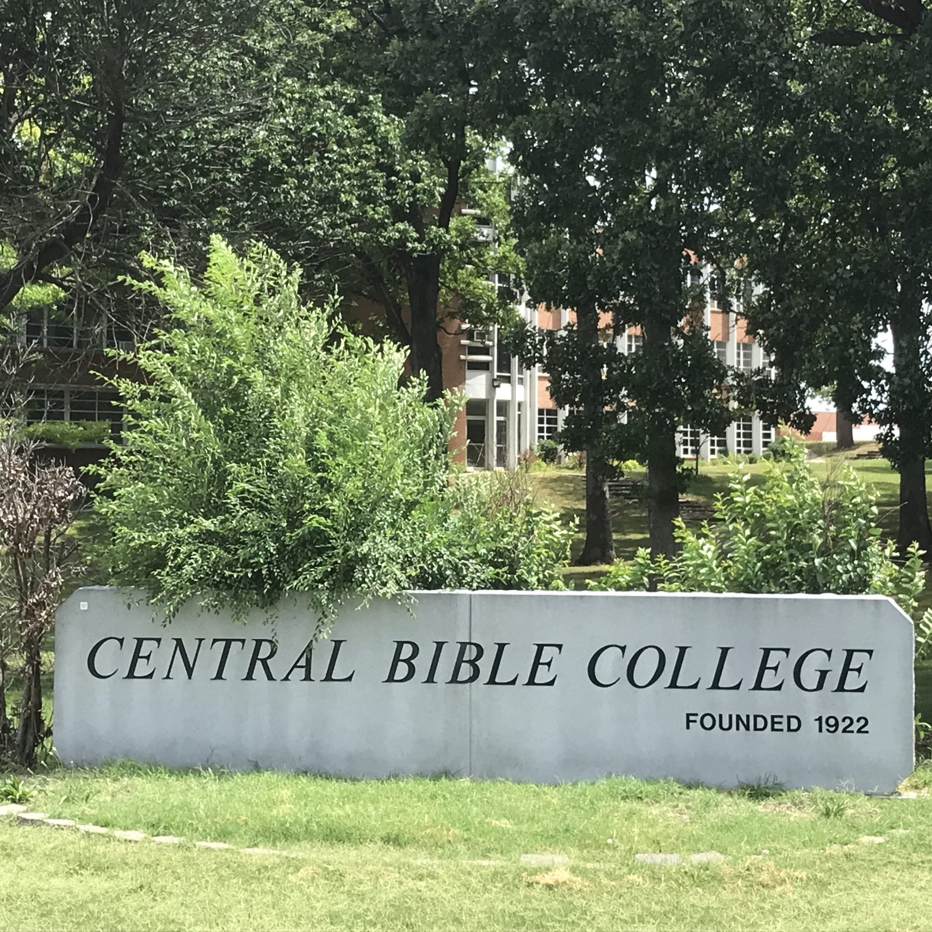 A concrete sign reading "Central Bible College, Founded 1922"