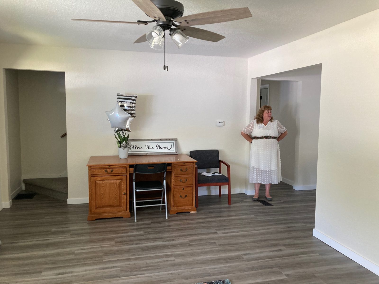 Abigail Cool, executive director of the Women's Medical Respite, stands in the living room of the new location for the program.