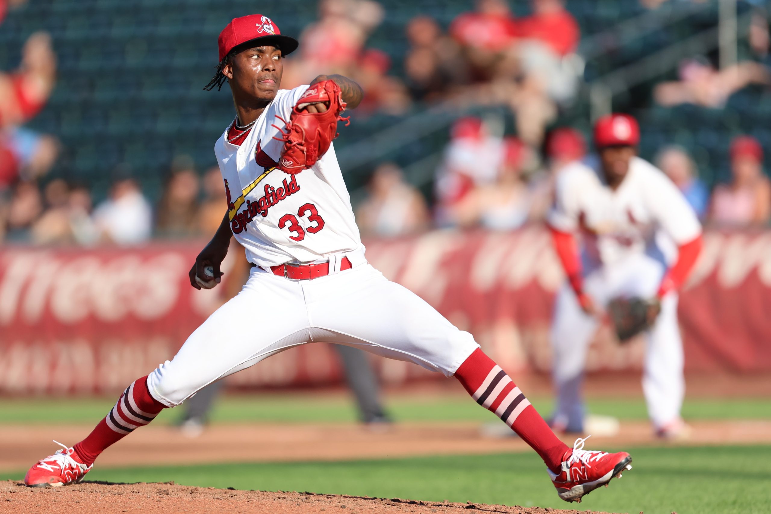 Tink Hence, wearing a Springfield Cardinals uniform, pitches the baseball during a game