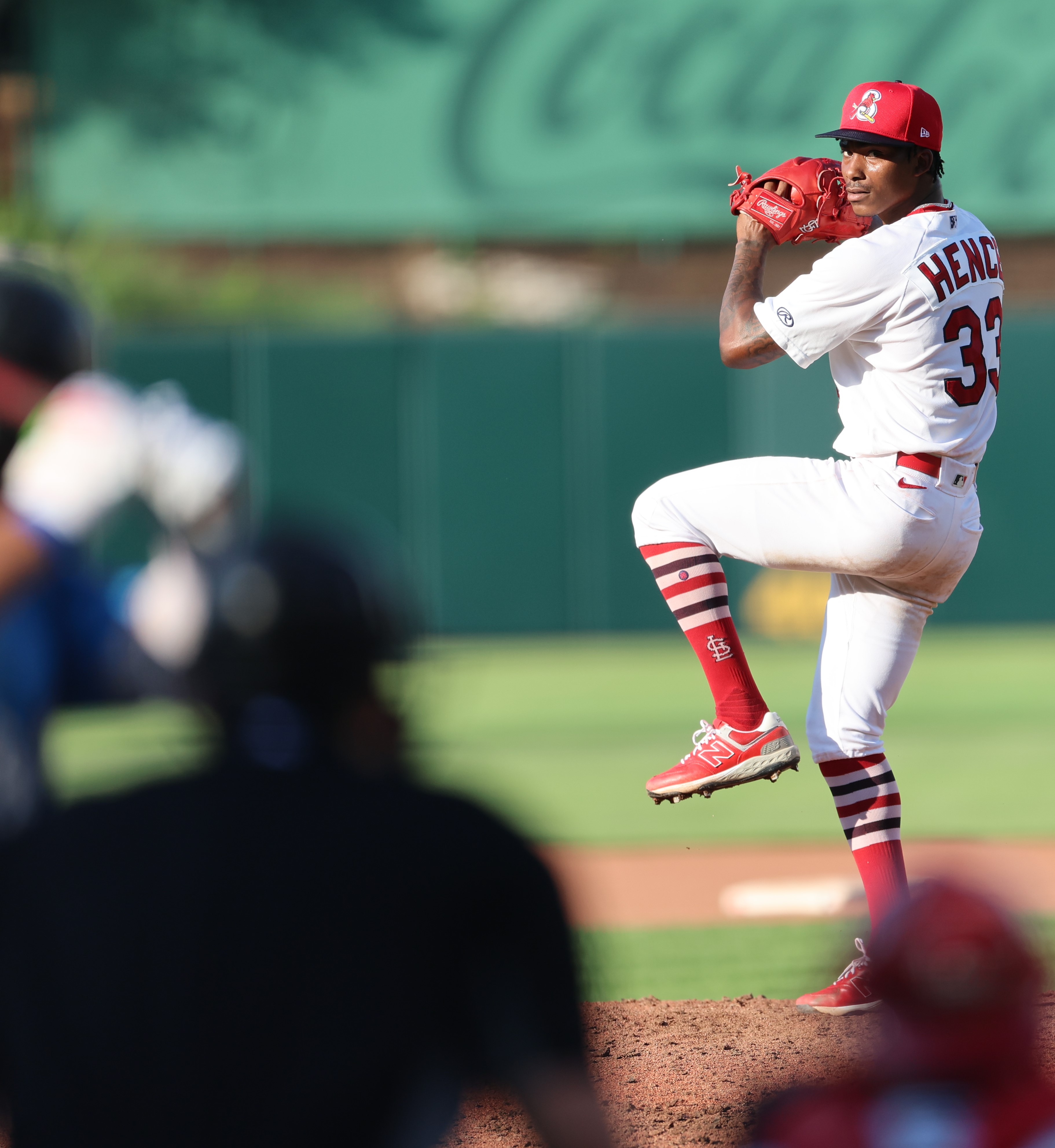 Tink Hence, wearing a Springfield Cardinals uniform, pitches the baseball during a game.