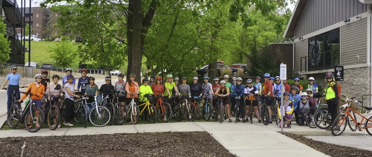 A group of more than 30 women pose with their bicycles outside Great Escape Beer Works in Springfield
