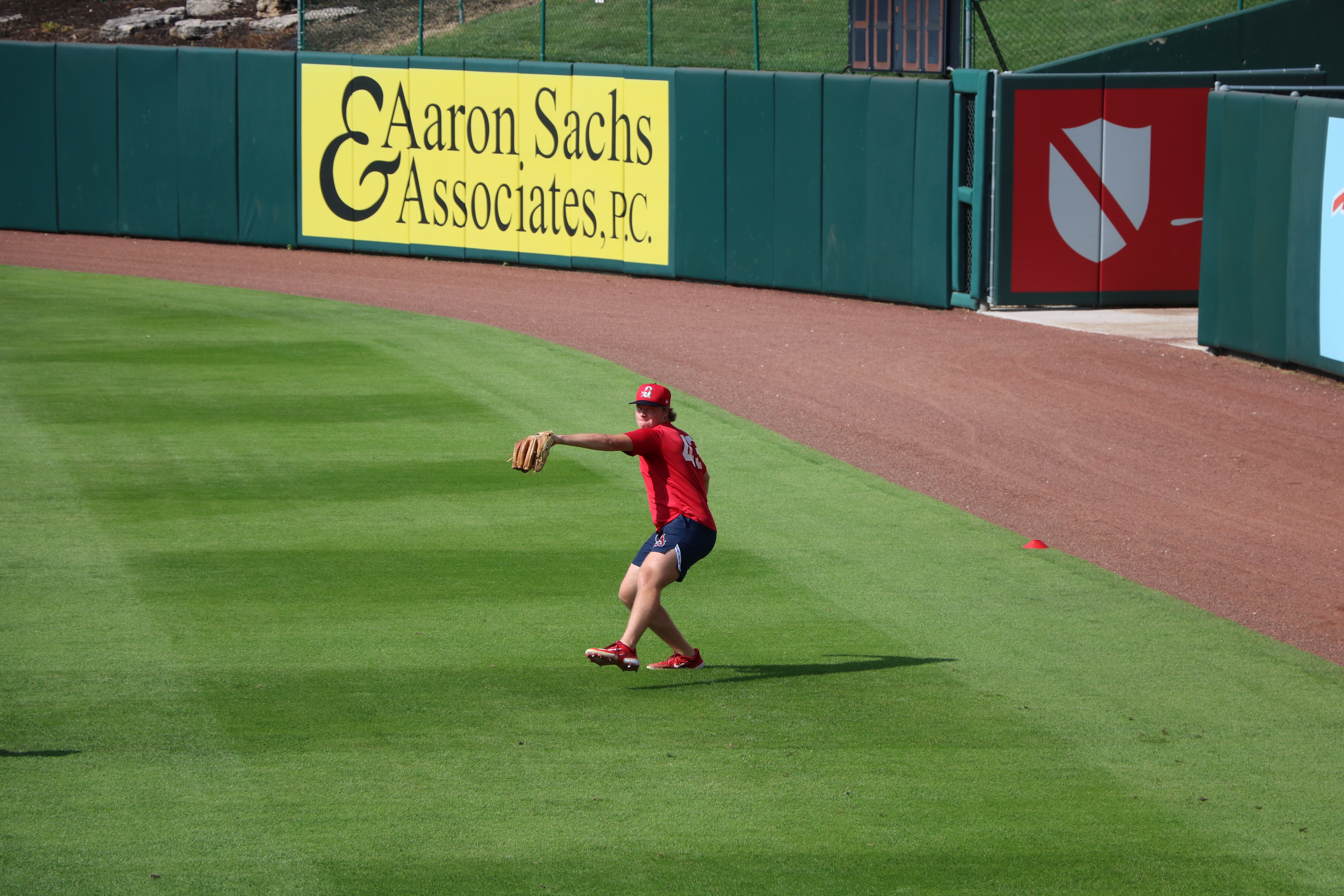 Tekoah Roby practices throwing the ball in the outfield at Hammons Field