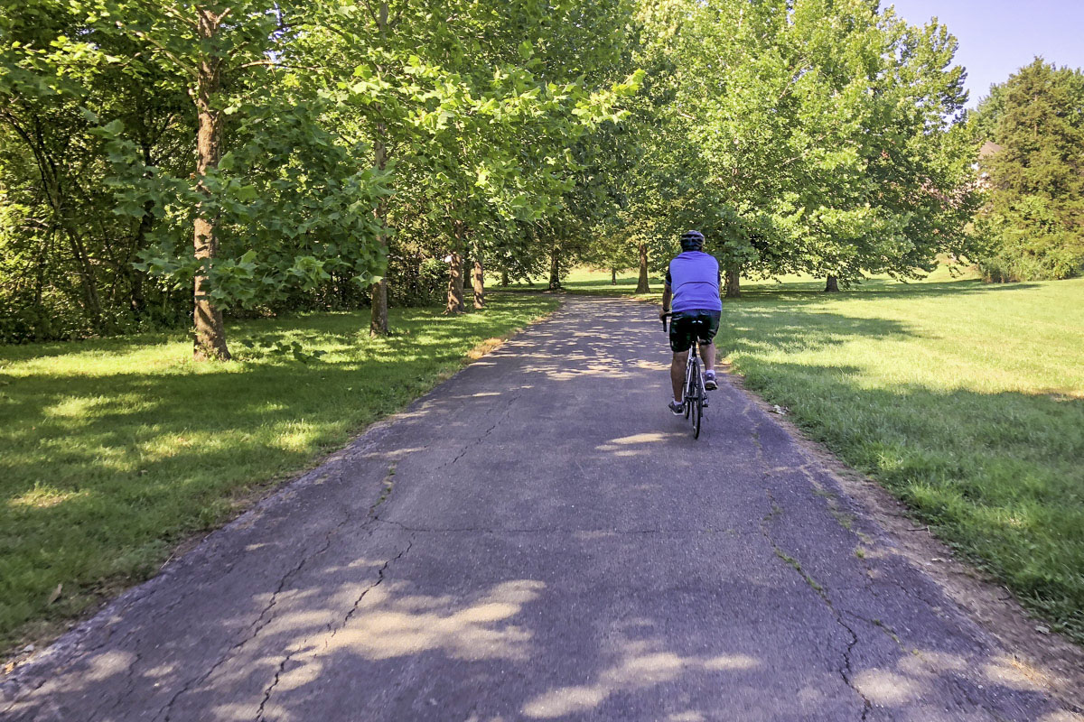 A cyclist peddles the South Creek Trail in Springfield.