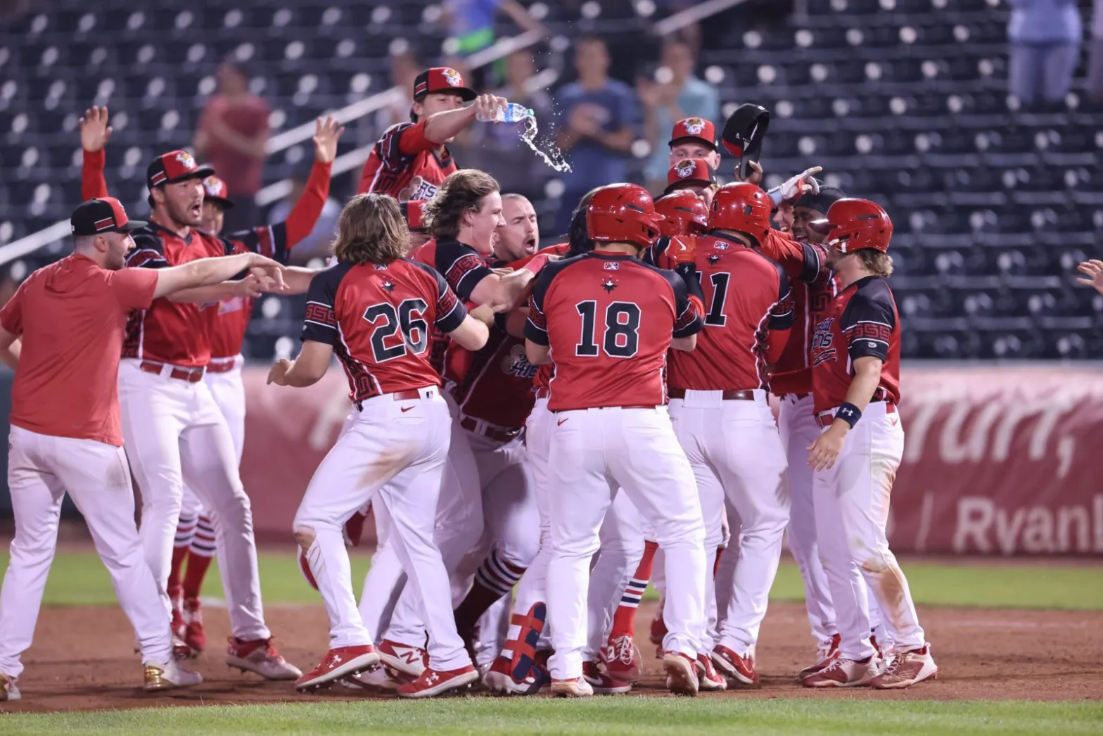 The Springfield Cardinals celebrate on the field after a walk-off win at Hammons Field