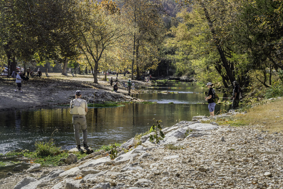 People line the banks, fishing at Roaring River