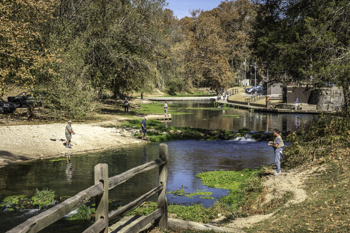 Anglers enjoy a warm fall day near the hatchery at Roaring River State Park.  