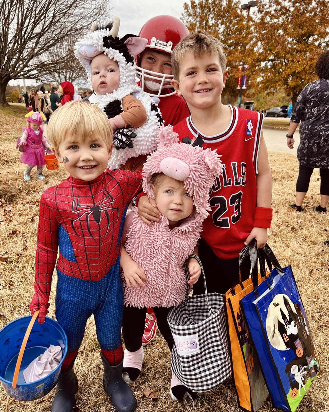 Five children in Halloween costumes pose for a photo
