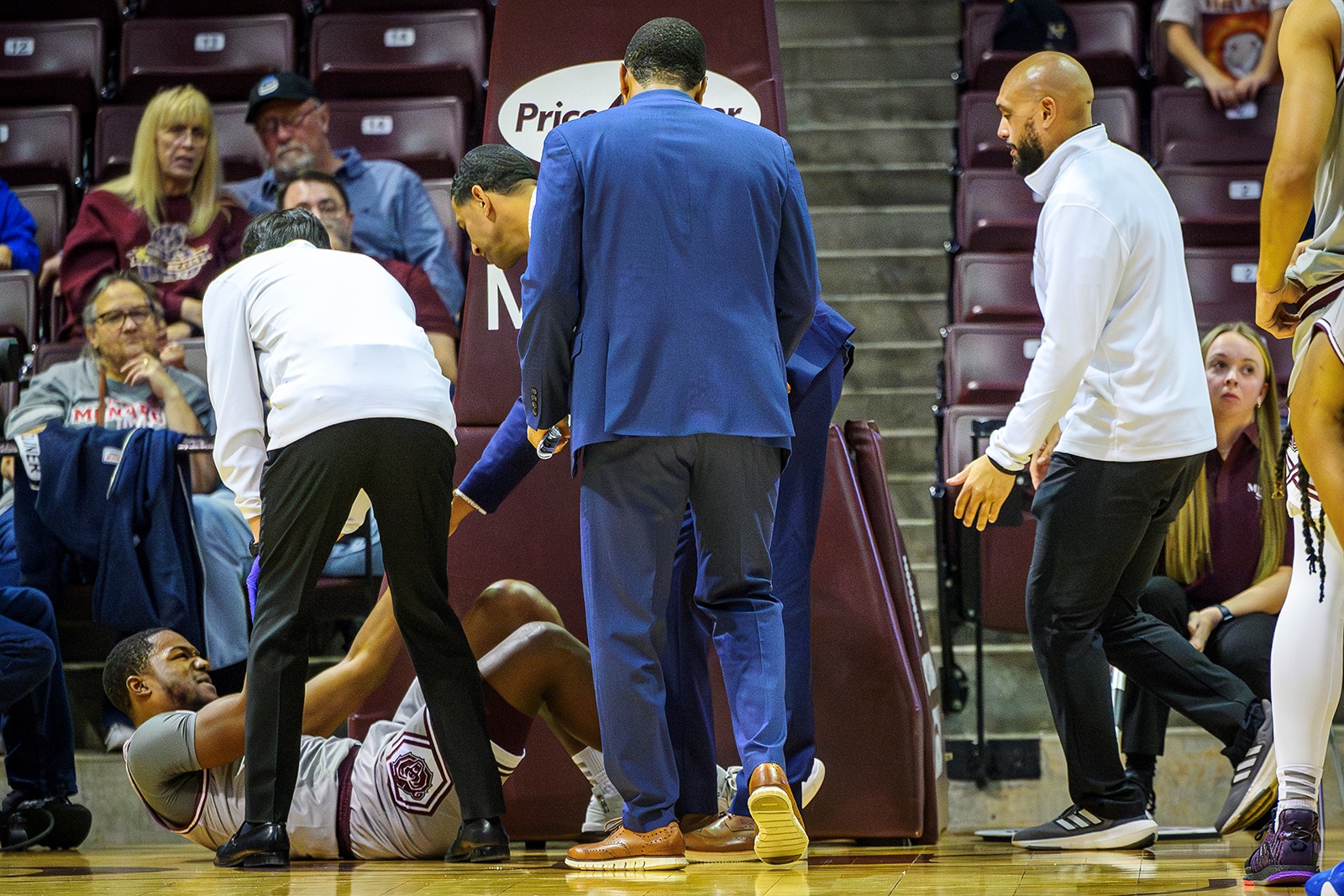 Trainers and coaches tend to Missouri State Basketball player Damien Mayo Jr. after he suffered an injury during a game