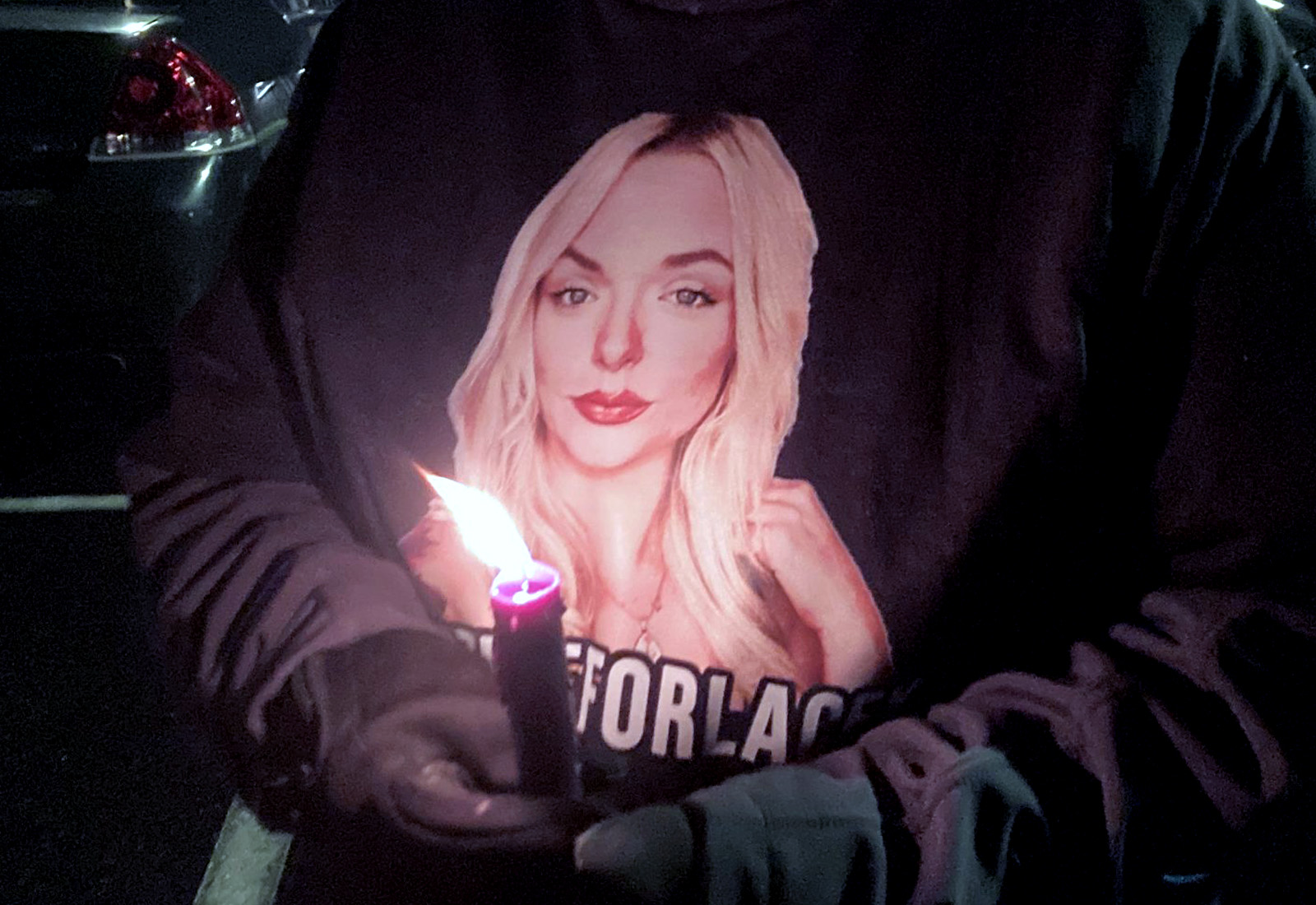 Friends and family of Lacey Nix wore shirts with Nix's image at the vigil Monday evening