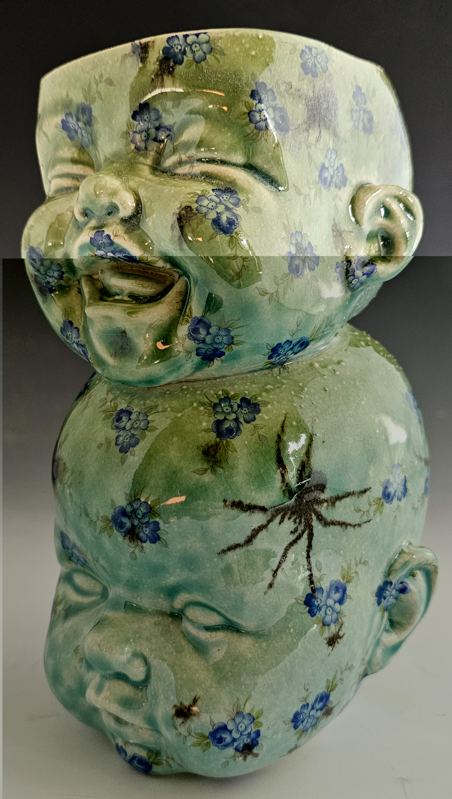 A ceramic vase made using baby head molds