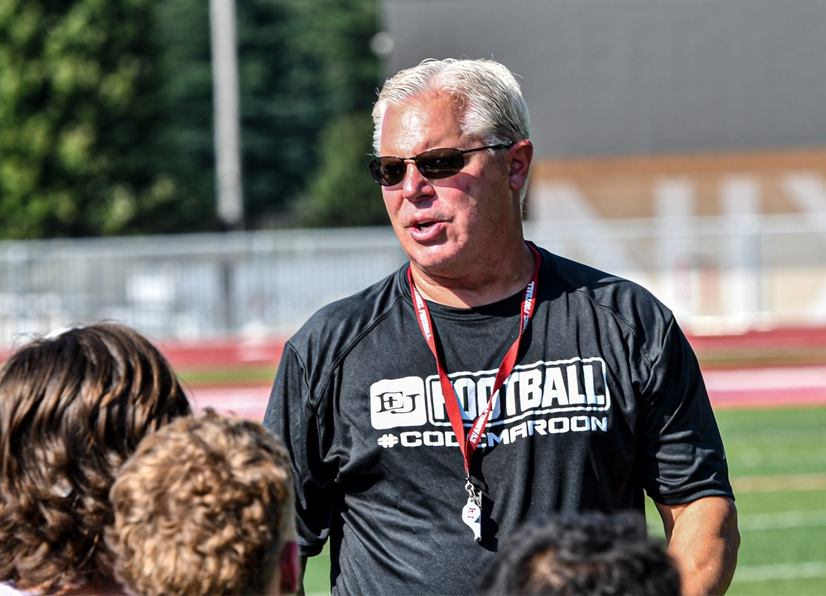 Evangel University football coach Chuck Hepola talks to his team
