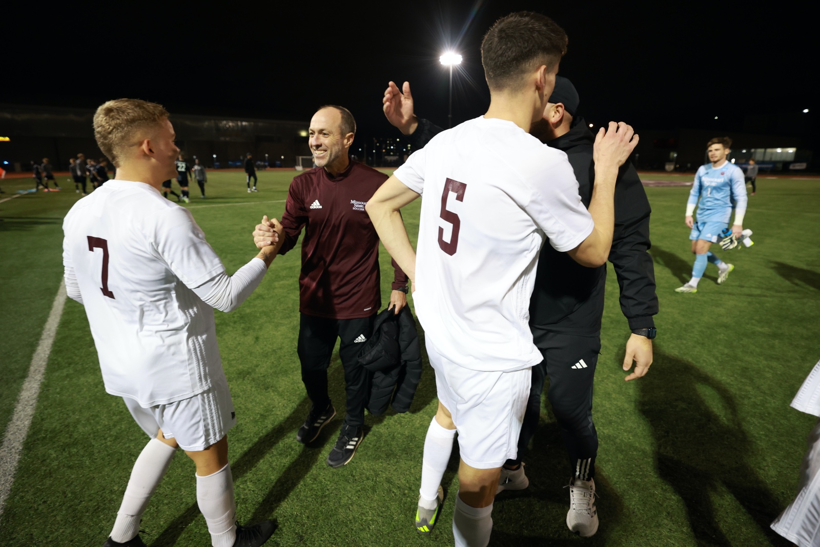 Missouri State men's soccer coach Michael Seabolt celebrates with his players after a win