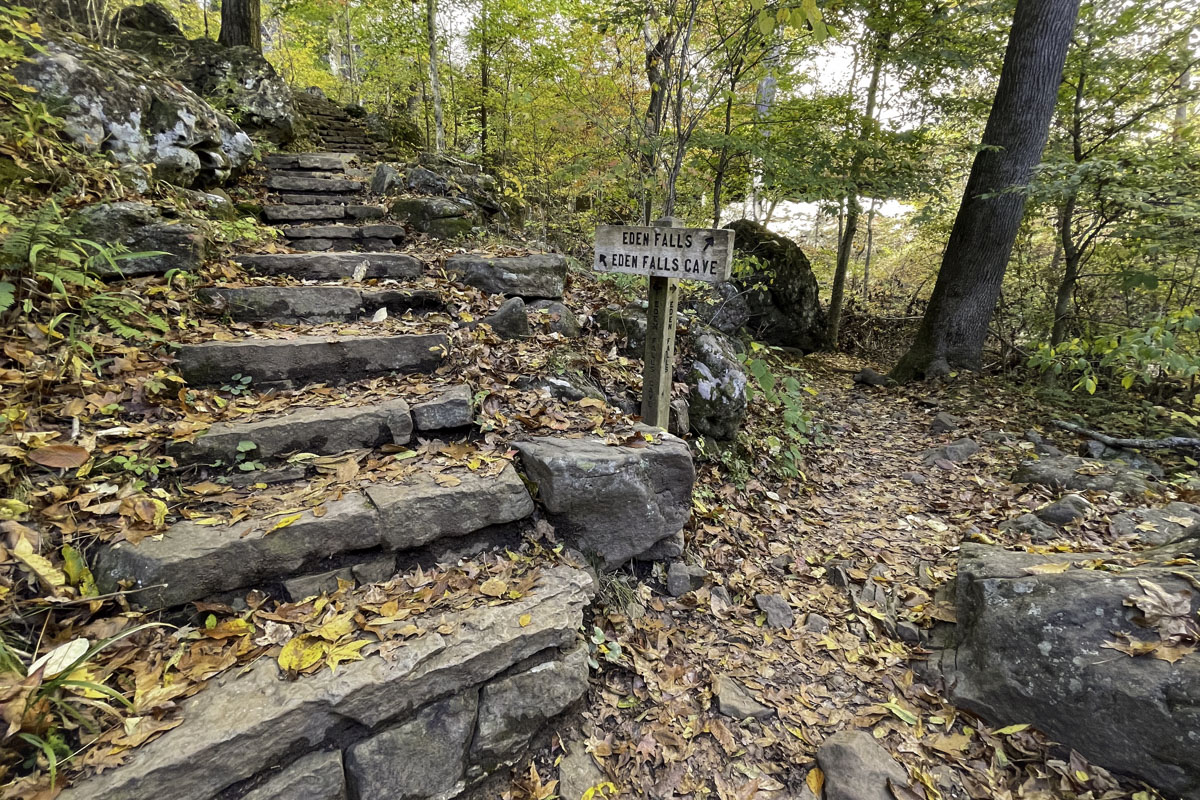 A sign points to additional stone steps to reach Eden Cave.