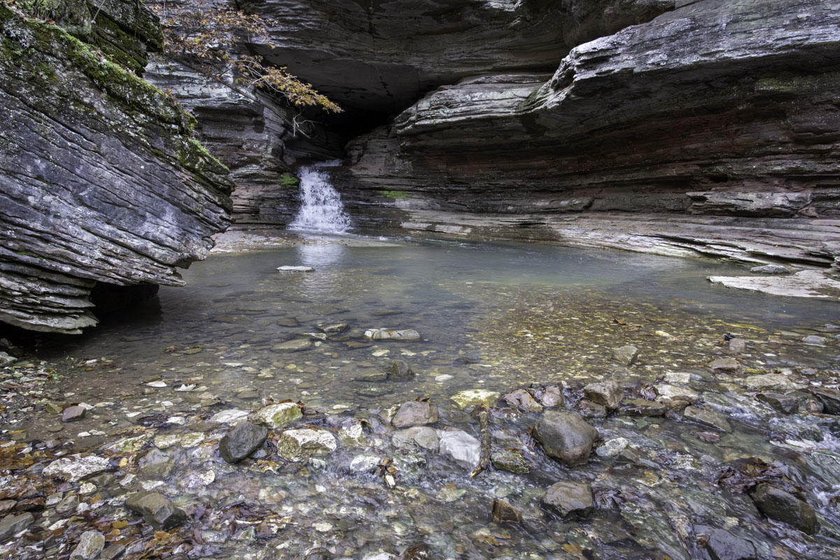 An 8-foot waterfall flows from the Natural Bridge cave, forming a pretty pool one early wet November in Lost Valley.
