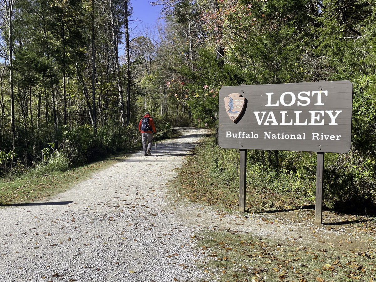 A gravel trail with a sign reading "Lost Valley, Buffalo National River"