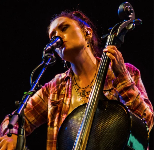 Singer/songwriter Molly Healey plays the cello and sings into a microphone