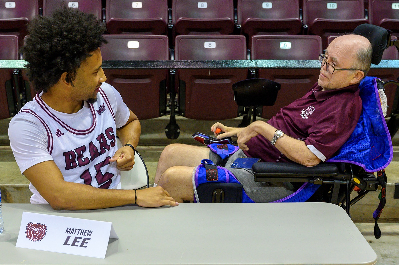 Art Hains, longtime Missouri State University sports broadcaster talks with guard Matthew Lee at the MSU Bears basketball teams’ media day on Oct. 19, 2023 at Great Southern Arena in Springfield.